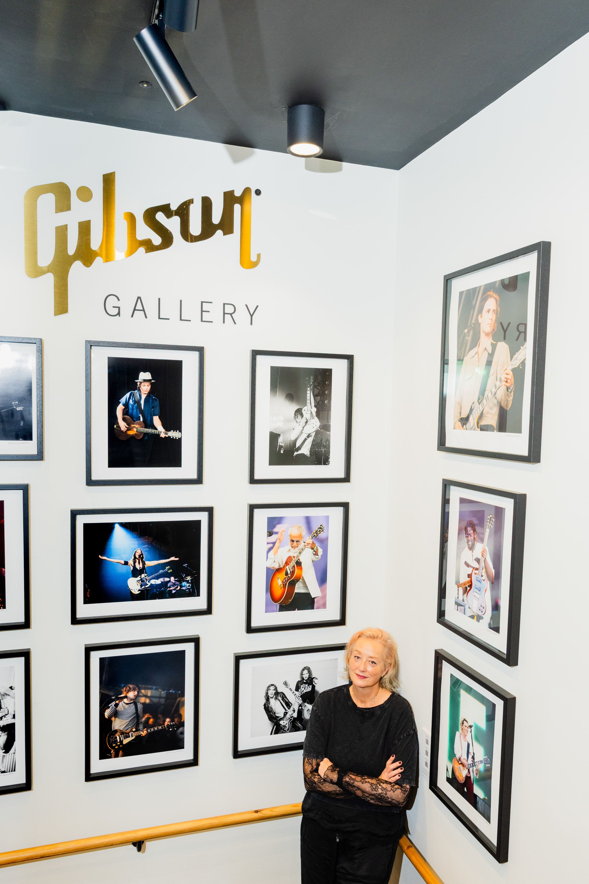 Framed colour and black and white music photographs arranged on the Gibson Gallery wall