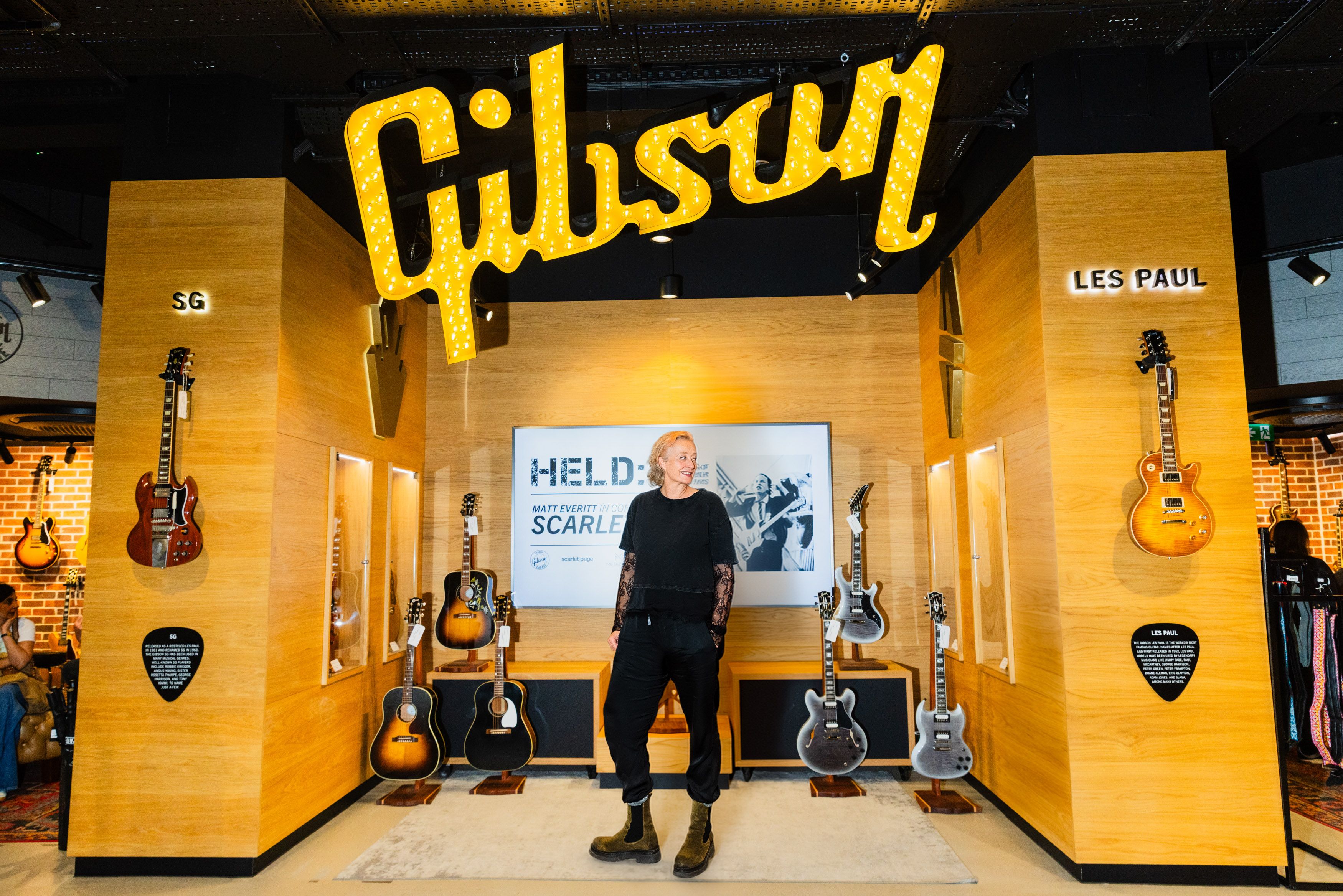 Scarlet Page among framed music photographs in the Gibson Gallery